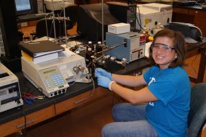 girl with goggle and gloves working in lab