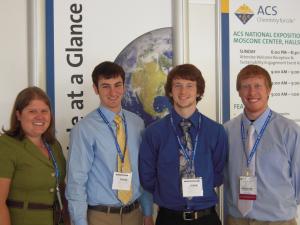 four chemistry students at presentation four chemistry students with name badges in front of poster at san francisco conference
