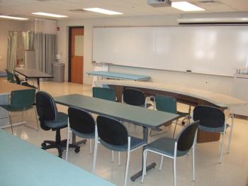 occupations lab classroom with desks, white board and bathroom lab in corner