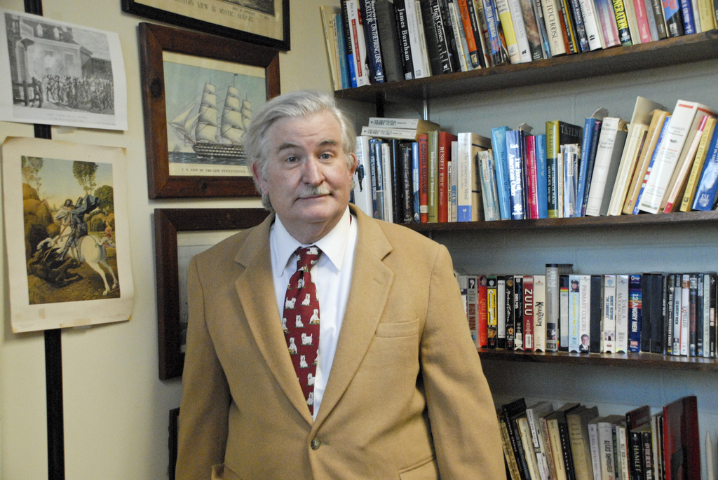 dr. wes mcdonald in from of various historical documents and photos