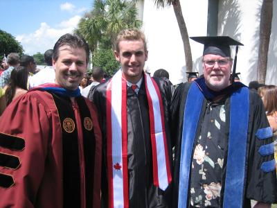 psychology alumni patrick smith with two others at a graduation