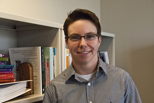 dr t evan smith in front of his bookshelves
