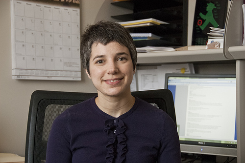 dr jean pretz in front of bookshelves and wall calendar