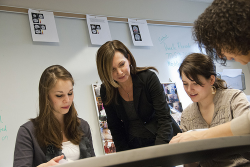 dr lemely working with three students at a table