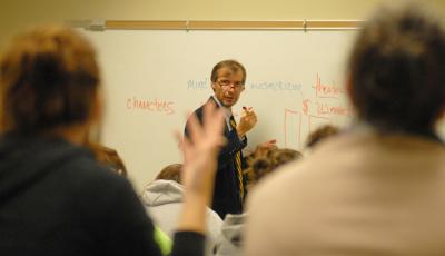 dr mike long calling on student from in front of whiteboard