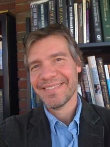 mike long close-up shot with books in back