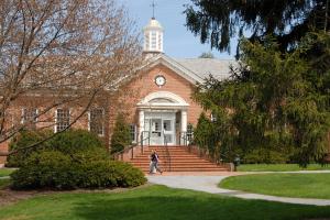outside of zug memorial hall with steps going up and steeple on top in fall