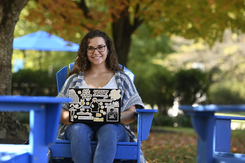 person sitting outside on laptop