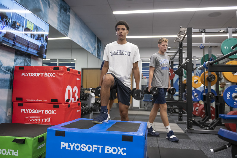 Student Lifting Weights