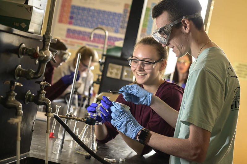 students with beakers
