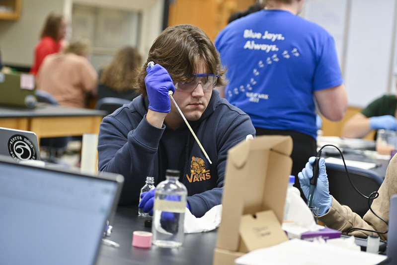 chemistry student with beakers