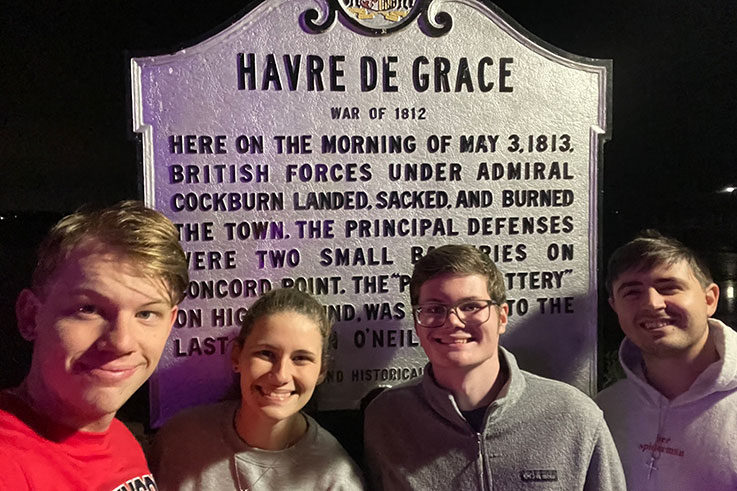 students in front of haverde sign