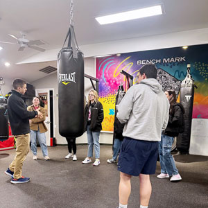 student with punching bag