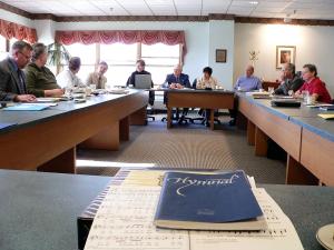 svmc board meeting in 2004 tables set up with close up of hymnal