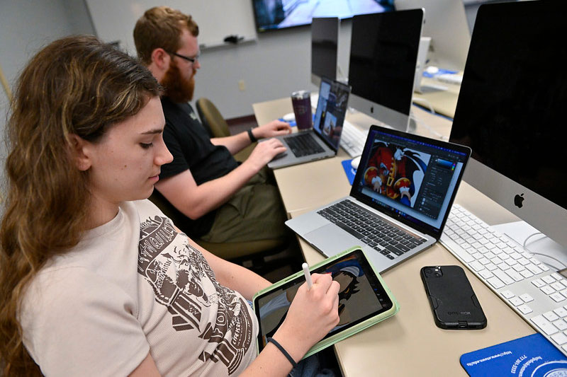 Student working on graphic design on iPad